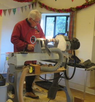 Chris Withall turning a tree ornament